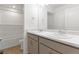 Bright bathroom featuring a double sink vanity with neutral cabinets and a bathtub with white tile surround at 2351 Monte Vista St, Fort Lupton, CO 80621