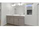 Bright bathroom featuring a double sink vanity with neutral cabinets and a window bringing in natural light at 2351 Monte Vista St, Fort Lupton, CO 80621