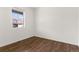 A cozy bedroom features a window view and hardwood flooring at 2351 Monte Vista St, Fort Lupton, CO 80621