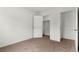 Bedroom featuring plush carpeting, neutral walls, base trim, and an open doorway to a walk-in closet at 2351 Monte Vista St, Fort Lupton, CO 80621