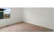 This bedroom has neutral carpet and a large window for natural light at 2351 Monte Vista St, Fort Lupton, CO 80621