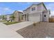 Well-maintained two-story home with a driveway, gray siding, and a neatly landscaped front yard at 2351 Monte Vista St, Fort Lupton, CO 80621