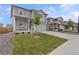 Charming two-story home with a well-manicured lawn, gray siding, and a welcoming front porch at 2351 Monte Vista St, Fort Lupton, CO 80621