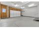 Spacious garage with concrete floors, an overhead door, and lighting fixtures adding functionality at 2351 Monte Vista St, Fort Lupton, CO 80621