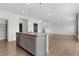 Open-concept kitchen features an island with granite countertops and modern gray cabinetry at 2351 Monte Vista St, Fort Lupton, CO 80621