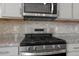 This kitchen features stainless steel appliances, a modern range, and stylish backsplash at 2351 Monte Vista St, Fort Lupton, CO 80621