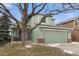 Charming two-story home with a well-maintained lawn and two-car garage at 9401 Wolfe St, Highlands Ranch, CO 80129