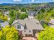 A home aerial view displays the backyard, patio, and mountain views at 6506 S Robb Way, Littleton, CO 80127