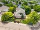 A lush backyard with mature trees, garden area, stone patio and outdoor seating creating a private outdoor retreat at 6506 S Robb Way, Littleton, CO 80127