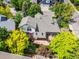 Aerial view of a backyard patio with dining set, lush landscaping with garden area, and privacy fence at 6506 S Robb Way, Littleton, CO 80127