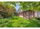 Sprawling backyard with covered patio, table, and privacy fence at 6506 S Robb Way, Littleton, CO 80127