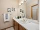 Bright bathroom vanity with a large mirror and ample counter space at 6506 S Robb Way, Littleton, CO 80127