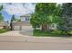 Inviting two-story home with brick accents, a three-car garage, and a beautifully landscaped front yard at 6506 S Robb Way, Littleton, CO 80127
