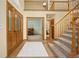 Spacious foyer featuring hardwood floors, a staircase, and a view into the adjacent rooms at 6506 S Robb Way, Littleton, CO 80127