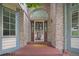 Welcoming front entrance with a decorative door, brick facade, sidelights, and 'Welcome' mat at 6506 S Robb Way, Littleton, CO 80127