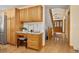 Hallway with hardwood floors, staircase with wooden railings, and a built-in desk and cabinets at 6506 S Robb Way, Littleton, CO 80127