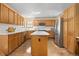 Traditional kitchen with hardwood floors, granite countertops, central island and stainless steel appliances at 6506 S Robb Way, Littleton, CO 80127