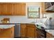 Well-lit kitchen with updated stainless steel appliances and granite countertops at 6506 S Robb Way, Littleton, CO 80127