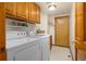 Laundry room with washer, dryer, and storage cabinets at 6506 S Robb Way, Littleton, CO 80127