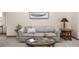 Cozy living room with a comfortable sofa, glass coffee table, and natural light at 6506 S Robb Way, Littleton, CO 80127