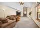 Spacious living room featuring a fireplace, vaulted ceilings, large windows and comfortable furniture at 6506 S Robb Way, Littleton, CO 80127