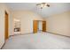 Spacious bedroom with neutral carpet, vaulted ceiling, and adjoining bathroom at 6506 S Robb Way, Littleton, CO 80127