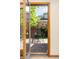 Outdoor patio with table and chairs, seen through an open glass door, providing a relaxing backyard view at 6506 S Robb Way, Littleton, CO 80127