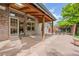 Wide view of a covered patio with brick exterior and outdoor dining area at 6506 S Robb Way, Littleton, CO 80127