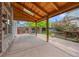 View of the home's covered patio, wooden ceiling and exterior landscaping at 6506 S Robb Way, Littleton, CO 80127