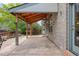 Spacious patio with wood pergola attached to the home's brick exterior with a door to the interior at 6506 S Robb Way, Littleton, CO 80127