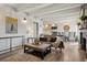 Bright living room with beamed ceilings flows into kitchen and dining room at 655 N Pearl St # 301, Denver, CO 80203
