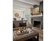 Comfortable living room with fireplace, sofa and center ottoman at 655 N Pearl St # 301, Denver, CO 80203