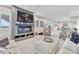 Open-concept basement with a fireplace, plush seating, and access to the kitchen area at 6930 Hyland Hills St, Castle Pines, CO 80108