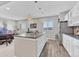 Wide view of the basement bar area with seating and kitchen access at 6930 Hyland Hills St, Castle Pines, CO 80108