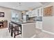 Basement bar area with pendant lights, a wine fridge, and seating for four at 6930 Hyland Hills St, Castle Pines, CO 80108