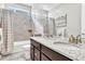 Elegant bathroom featuring a double sink vanity with granite countertops and a tub-shower combo at 6930 Hyland Hills St, Castle Pines, CO 80108