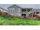 Back exterior view of the home showcasing the deck, outdoor living space and backyard at 6930 Hyland Hills St, Castle Pines, CO 80108