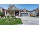 Charming home with a welcoming porch, well-manicured lawn, and two car garage for a lovely curb appeal at 6930 Hyland Hills St, Castle Pines, CO 80108