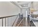 Elegant hallway with dark wood floors, staircase, and a view towards the front door at 6930 Hyland Hills St, Castle Pines, CO 80108