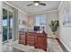 Functional home office with a large desk, natural light, and a view from the sliding glass door at 6930 Hyland Hills St, Castle Pines, CO 80108