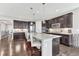 Bright kitchen with a center island, modern stainless-steel appliances, and dark cabinets at 6930 Hyland Hills St, Castle Pines, CO 80108