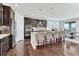 Gourmet kitchen with stainless steel appliances, granite countertops, and a spacious island with seating at 6930 Hyland Hills St, Castle Pines, CO 80108