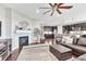 Inviting living room with a cozy fireplace and hardwood floors flowing into an open-concept kitchen at 6930 Hyland Hills St, Castle Pines, CO 80108