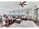 Spacious living room filled with natural light, a large sectional sofa, and views of the dining area at 6930 Hyland Hills St, Castle Pines, CO 80108