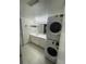 Cozy bathroom with stackable washer/dryer, white vanity, and bright overhead lighting at 9995 E Harvard Ave # 177, Denver, CO 80231