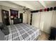 Well-lit bedroom featuring a large bed, ample closet space, and ceiling fan at 9995 E Harvard Ave # 177, Denver, CO 80231