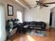 Inviting living room with ceiling fan, laminated floors, and a comfortable sofa at 9995 E Harvard Ave # 177, Denver, CO 80231