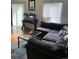 Bright living room featuring laminated floors, ceiling fan, and large windows at 9995 E Harvard Ave # 177, Denver, CO 80231