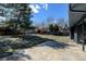 Spacious backyard boasts a stone patio, mature trees, green grass, and a shed at 7476 Park Lane Rd, Longmont, CO 80503