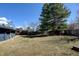 Expansive backyard with mature trees, a small playhouse, and some grass at 7476 Park Lane Rd, Longmont, CO 80503